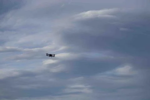 A Drone flying around the clouds. Stock Photos