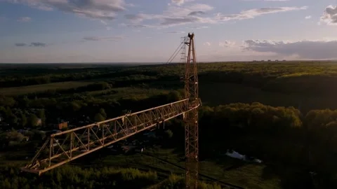 Drone flying around a construction crane in the sunset. Stock Footage 130574381