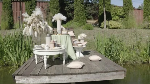 Drone flying around decorative table on pier Vidéo 330197797