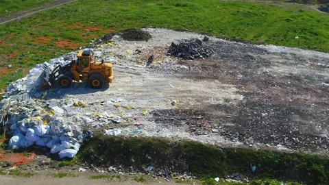 Drone flying around an excavator working at a junkyard Stock Footage 314213310
