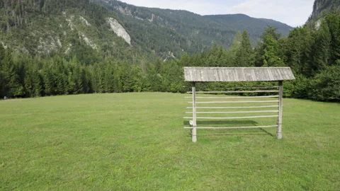 A drone flying around a hayrack on the right side of the frame. Video stock 217374615