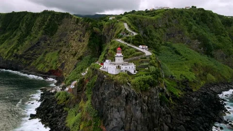 Drone flying around Lighthouse Farol Ponta do Arnel Stock Footage 224516919