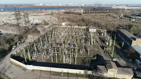 Drone is flying around a massive power station with towers and transformers Stock Footage 160114725