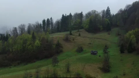 Drone flying around small mountain cabin in Carpathian Mountains. Morning fog Stock Footage 154425066