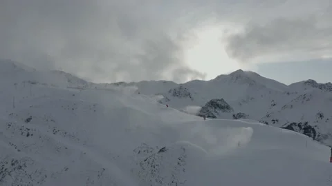 Drone flying around the snowmaker in action when the slope are closed for co Stock Footage 145699708