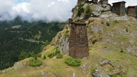 Drone flying around the tower of old monastery ruins in the mountains Stock Footage 229879662