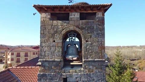 Drone flying away from ancient bell tower with stork nest Stock Footage 325529404