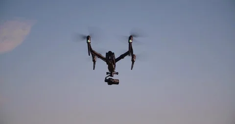 Drone flying away and filming in clear blue sky Stock Footage 113703460