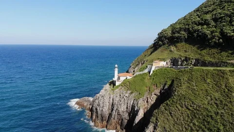 Drone flying away from cliff with lighthouse Stock Footage 114748123