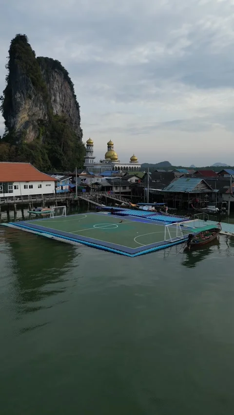 Drone Flying Away from Floating Soccer Field in Ko Panyi Village, Phang Nga, Stock Footage 335254961