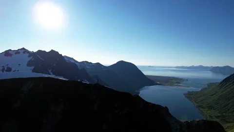 Drone flying away large-scale view mountain peak girl standing Stock Footage 222950149