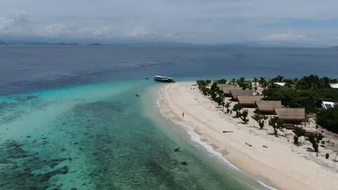 Drone flying away, man walking on the beach Stock Footage 303795564