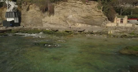 Drone flying away from operator at the beach Stock Footage 77702514