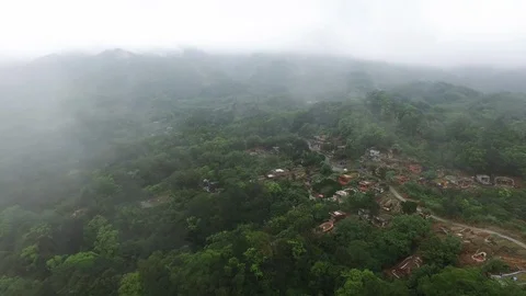 Drone flying away from small mountain village Stock Footage 85814182