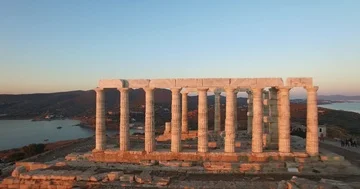 Drone flying from away from the temple of Poseidon during sunset time in Athens Stock Footage 85582770