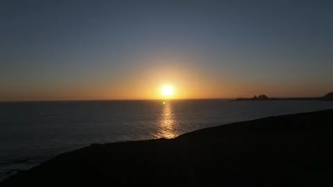 Drone Flying Back from Sunset and Descending Down Mountainside Stock Footage 309936452