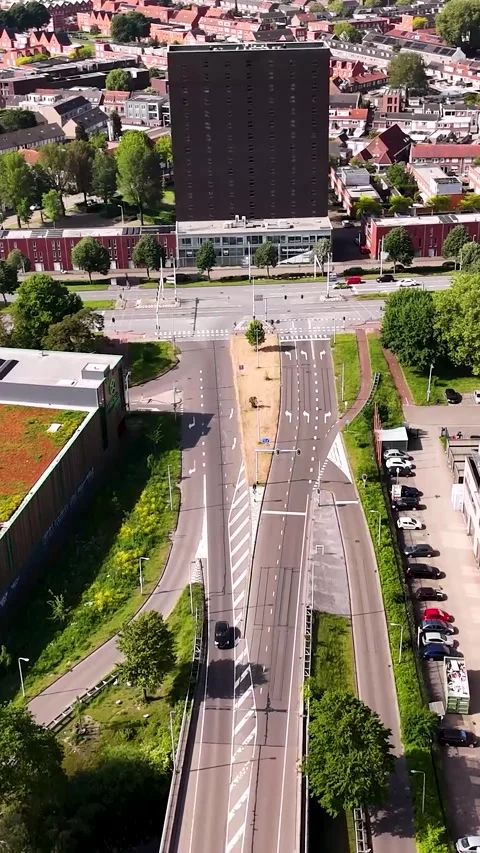 Drone flying backward above city road and residential building in europe 스톡 동영상 336496649