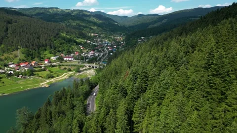 Drone flying backward along Bicaz Lake, Romania Stock Footage 312809195