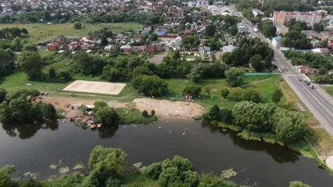 Drone flying backward and rising over river beach Stock Footage 333904619