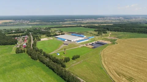 Drone flying backward high above rural farmland Stock Footage 333278770