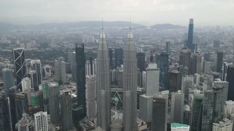 Drone flying backward from KLCC in Kuala Lumpur Stock Footage 150289347