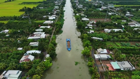 Drone flying backward over a cargo barge on a rural canal Stock-Footage 337526912