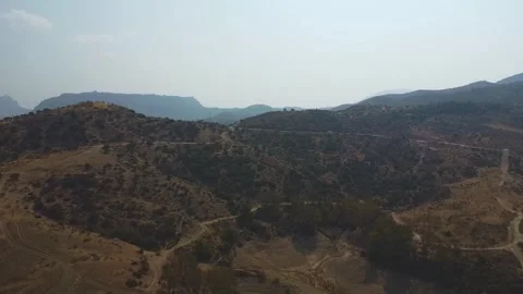 Drone Flying Backward Over Dry Mountain Landscape in Andalusia, Spain 動画素材 315213723