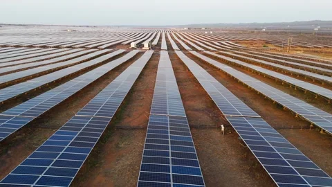 Drone Flying Backward Over Massive Solar Power Plant During Golden Hour Stock Footage 339187031