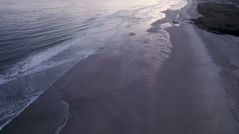 Drone flying backward over morning beach shoreline The Concept of coastal t.. Stock Footage 346459180