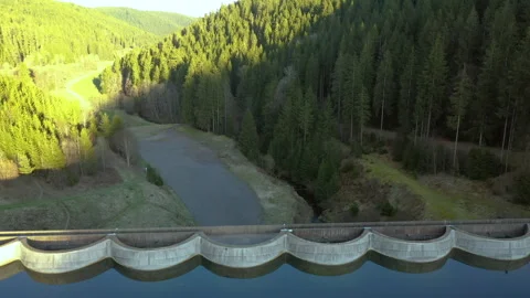 Drone flying backward revealing dam and forest valley, cinematic aerial landscap Stock-Footage 333069043