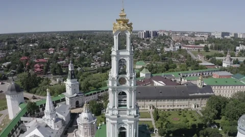 Drone flying backward rising from monastery clock tower Video stock 332309640