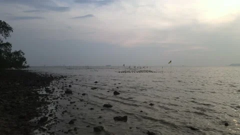 Drone flying backward from sea and passing through stone and sea waves Stock Footage 150721370