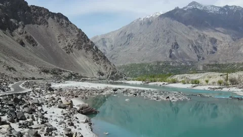 Drone flying backward from Shyok river in the mountains of Karakoram range Stock Footage 239931336