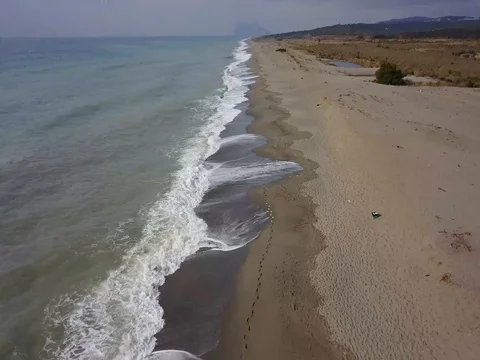 Drone flying backwards down Spanish beach 動画素材 80085860
