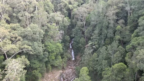 Drone flying backwards from Jeram Toi's Waterfall in Jelebu Stock Footage 149716944