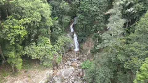 Drone flying backwards from Jeram Toi's Waterfall in Jelebu Stock Footage 149717005