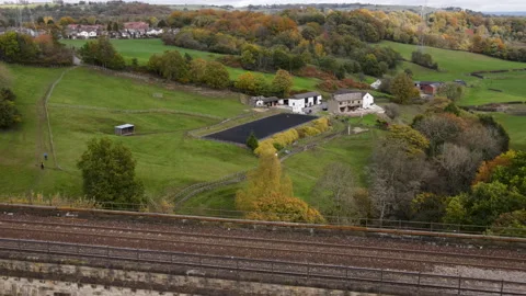 Drone Flying Backwards Over Autumnal Forest, River, Aquaduct and Trainline,  動画素材 220108122