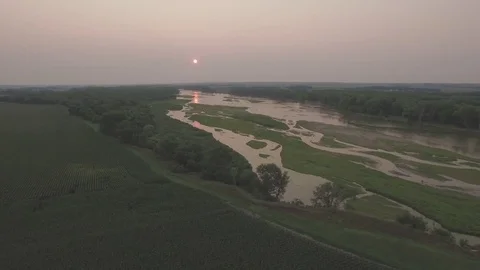 Drone Flying Backwards Over Cornfield From River Raw Stock Footage 78885311