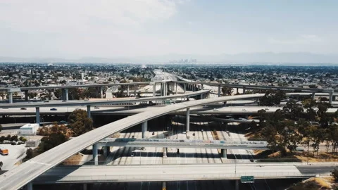 Drone flying backwards over large highway interchange in Los Angeles, USA with Stock Footage