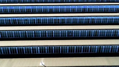 Drone flying backwards over old, characteristic, patterned factory roof Stock Footage 138685212