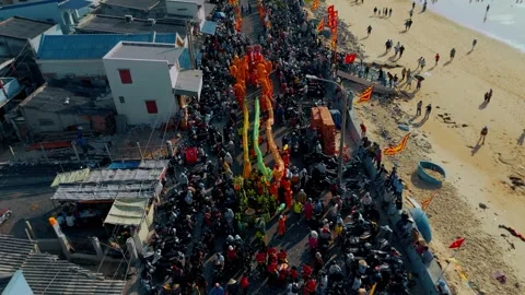 Drone Flying Backwards Over Phuoc Hai Coastal Festival Procession Stock Footage 334329899