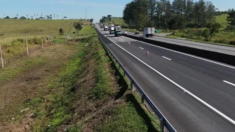Drone flying backwards over road in the countryside of Brazil Stock Footage 133938239