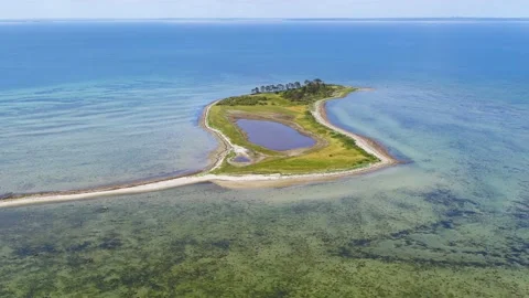 Drone flying backwards over small island of Alholm in Denmark 4K Stock Footage 236723301