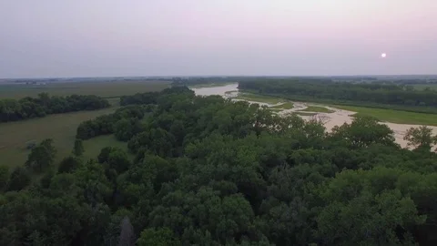 Drone Flying Backwards Over Trees From River Stock Footage 78887393