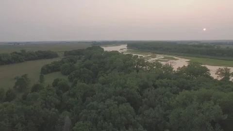 Drone Flying Backwards Over Trees From River Raw Stock Footage 78887394