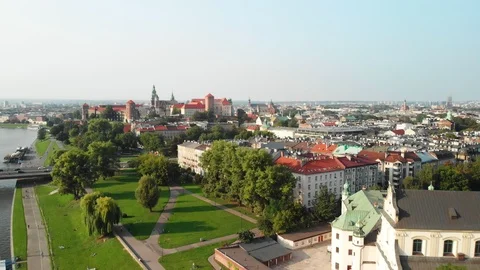 Drone flying backwards over Vistula River, Krakow Old Town, Poland Stock Footage 99323218