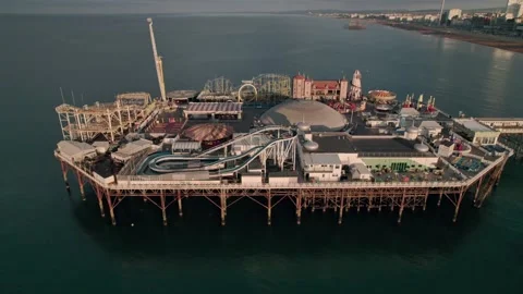Drone flying backwards to reveal empty funfair in the end of Brighton Pier and Stock Footage 194494080