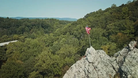 Drone flying backwards revealing the Flag of the United States of America Stock Footage 162707593
