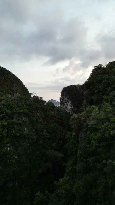 Drone Flying Backwards Revealing a Limestone Karst Landscape in Ao Nang, Krabi, Stock Footage 334779757