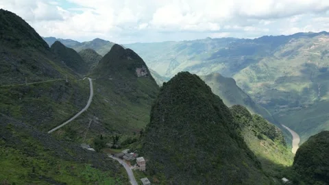 Drone Flying Backwards Revealing Mountain Valley Landscape in Ha Giang, Vietnam Stock Footage 334619832